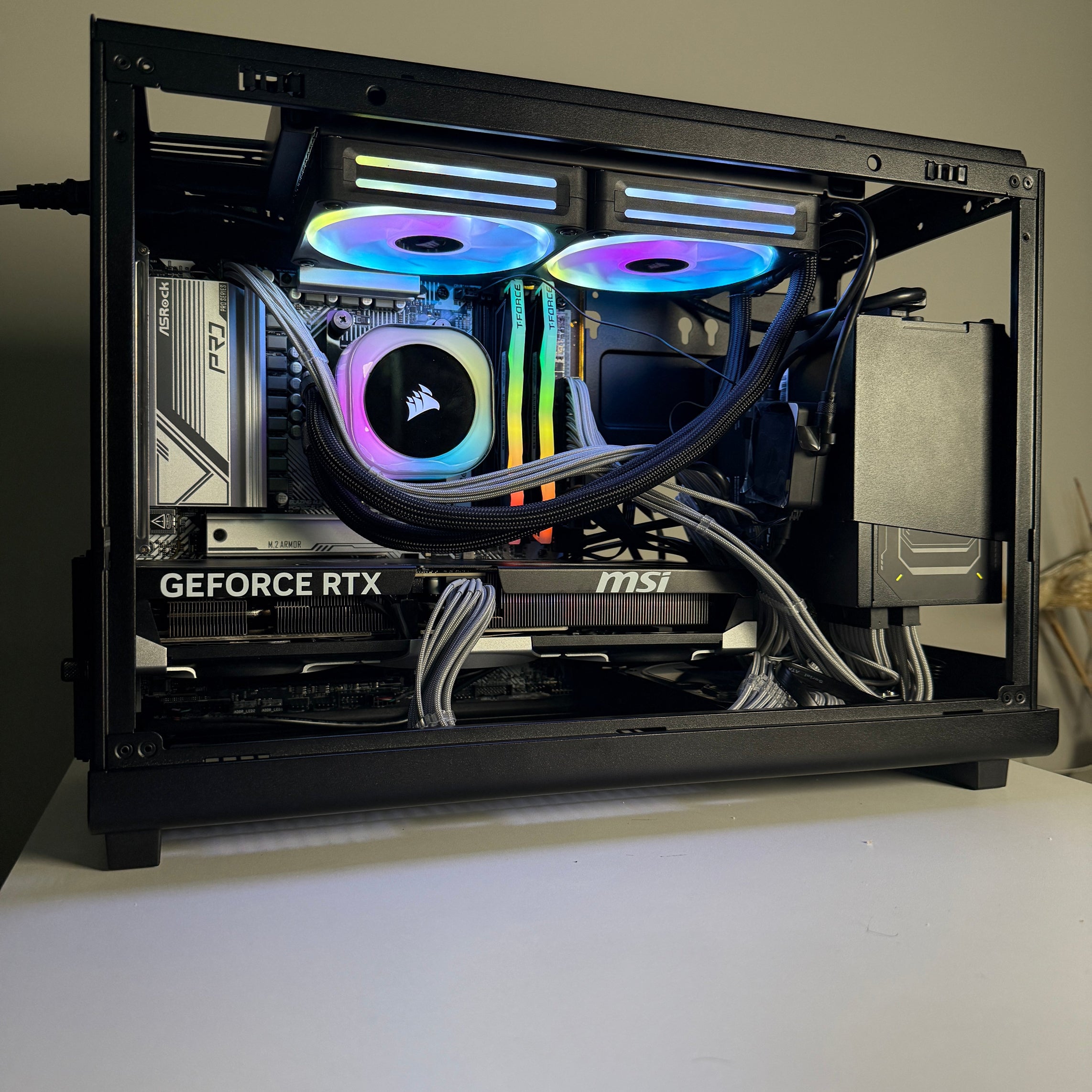 Open computer case with RGB lighting on a white surface